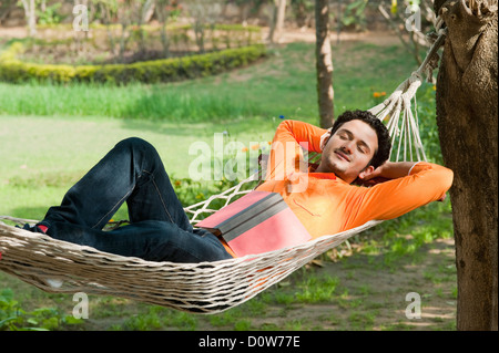 Man napping in a hammock Stock Photo