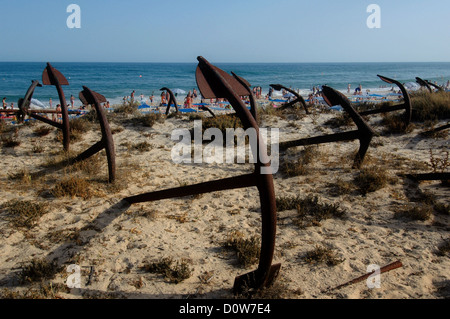 The Cemiterio das Ancoras Cemetery of Anchors / Anchor Graveyard a rusting memorial to the former fishing fleet, which comprises of the anchors used for tuna fishing embedded into the sand dunes close to the Praia do Barril Beach, located on the Ilha de Tavira in Algarve Southern region of Portugal Stock Photo