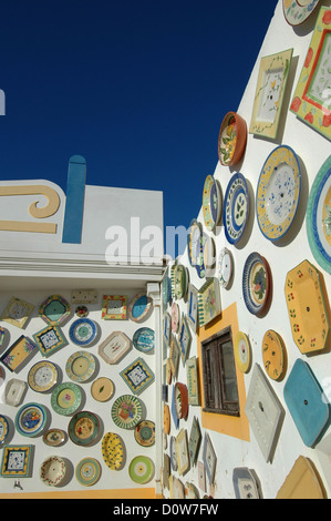 Traditional Portuguese hand painted plates decorating exterior of an artisan pottery wall in Cape St. Vincent next to the Sagres Point, on the so-called Costa Vicentina (Vincentine Coast), a headland in the municipality of Vila do Bispo, in the Algarve, southern Portugal. Stock Photo