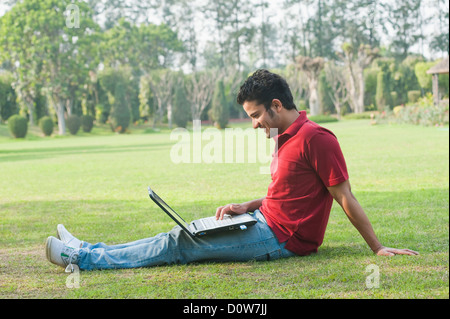 Man working on a laptop and smiling Stock Photo