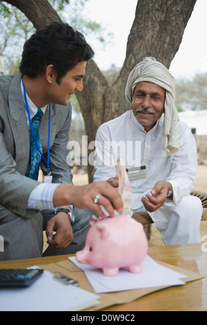 Financial advisor explaining to a farmer about agriculture loan, Hasanpur, Haryana, India Stock Photo