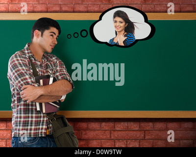 University student thinking of his girlfriend in a classroom Stock Photo