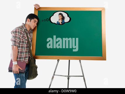 University student thinking of his girlfriend in a classroom Stock Photo