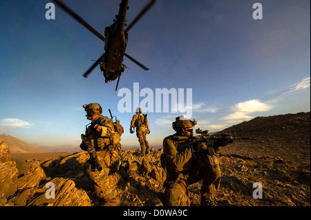 US Air Force Pararescuemen with the 83rd Expeditionary Rescue Squadron secure an area after being lowered from an HH-60 Pave Hawk during a mission November 7, 2012 in Afghanistan. Stock Photo