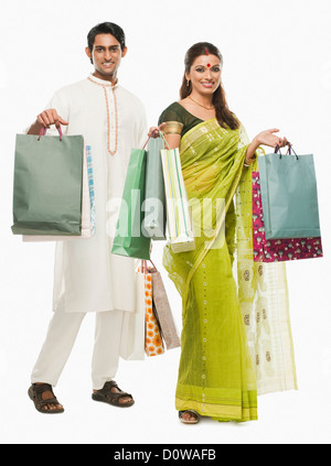 Bengali couple carrying shopping bags and smiling Stock Photo