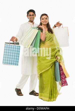 Bengali couple carrying shopping bags and smiling Stock Photo