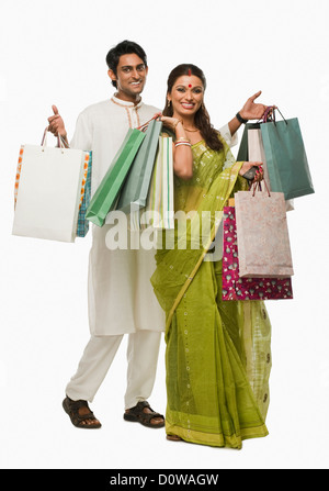 Bengali couple carrying shopping bags and smiling Stock Photo