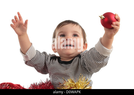 Eight months baby inside a box showing a christmas ball in a white background Stock Photo