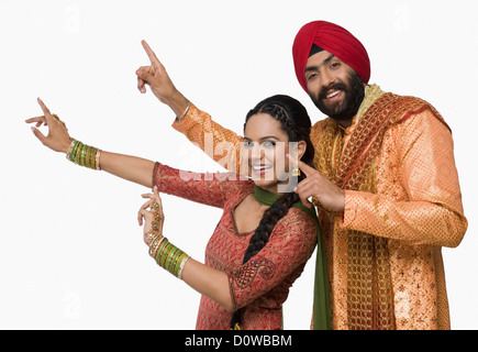 Sikh couple doing Bhangra the folk dance of Punjab in India Stock Photo