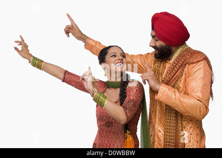 Sikh couple doing Bhangra the folk dance of Punjab in India Stock Photo