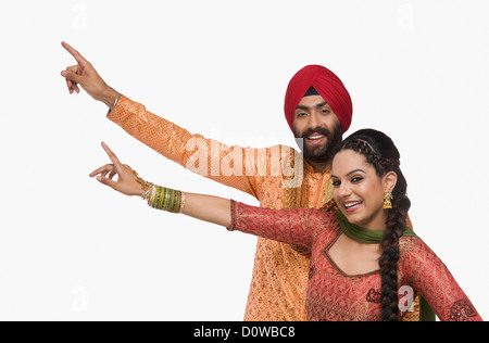 Sikh couple doing Bhangra the folk dance of Punjab in India Stock Photo