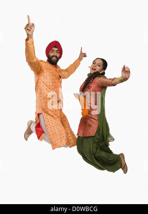 Sikh couple doing Bhangra the folk dance of Punjab in India Stock Photo