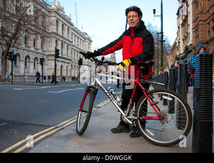 London, UK, 1 December 2012; Gayzer Frackman (51) with his bike after cycling for six days between Lytham and London. Mr Frackman arrived in London to hand an open letter in to 10 Downing St asking on the Prime Minister’s policy on fracking (the extraction of shale gas) (the extraction of shale gas). Mr Frackman’s house was damaged by an earthquake reportedly caused by fracking taking place at Preese Hall Farm in Lytham Stock Photo
