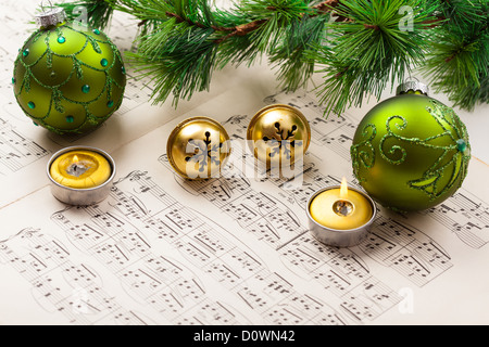 Christmas carol with jingle bells and candles Stock Photo