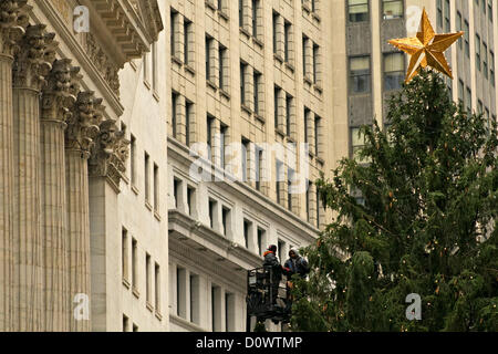 December 1, 2012, New York, NY.  Workers string lights on Christmas tree outside New York Stock Exchange to prepare for lighting ceremony on December 4. Stock Photo