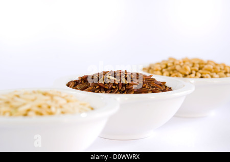 different grains , rice , red rice , wheat in bowl Stock Photo