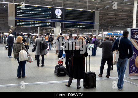 St. Pancras International Train Station in London. National and Eurostar trains passengers watching departure board for trains. Stock Photo