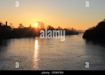 2nd December 2012. Hampton Court, SW London, UK. Sunrise over the River Thames from Hampton Court Bridge. Stock Photo