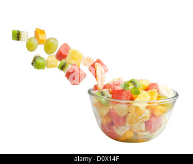 Fruits salad flies to the bowl isolated on white background Stock Photo