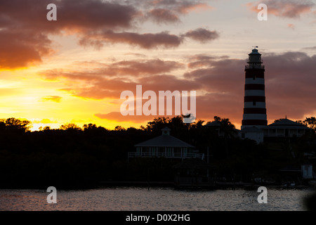 Hopetown Lighthouse silhouette at sunset. The highlighted silhouette of the famous hopetown lighthouse against a bright sky Stock Photo