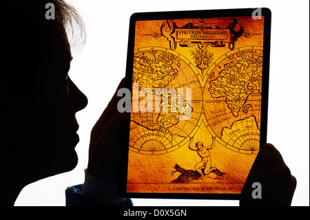 silhouette of woman with old map on digital tablet Stock Photo