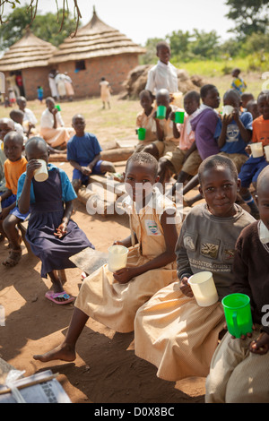 Students receive porridge at break time a school in Amuria, Uganda, East Africa. Stock Photo