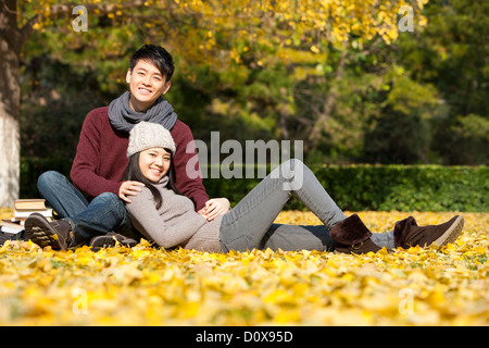 Sweet college couple with books enjoying the nice autumn day on campus Stock Photo