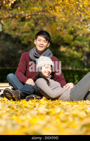 Sweet college couple with books enjoying the nice autumn day on campus Stock Photo