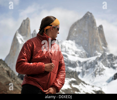Woman zips her jacket in front of Monte Fitz Roy in Los Glaciares National Park, El Chalten, Argentina Stock Photo