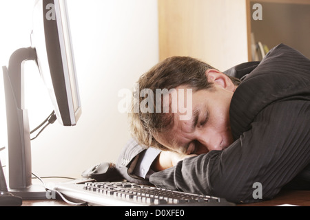 Businesman sleeping on workplace Stock Photo