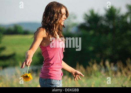 Teenage girl holding flower Stock Photo