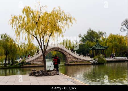 A photographer take the picture at the lakeside in Yangzhou Stock Photo