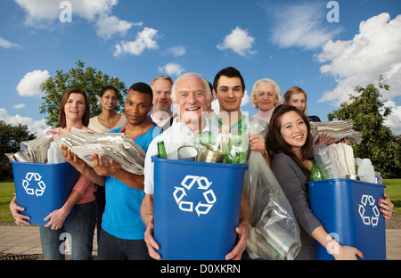 Group of people with recycling in bins Stock Photo