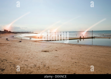 Beach scene with rays of light, Margate, Kent, UK Stock Photo