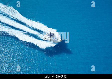 Motor yacht ploughing across blue sea Stock Photo