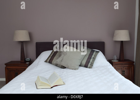 Bedroom with open book on bed Stock Photo