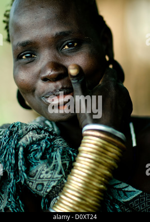 Portrait Of A Smiling Bodi Tribe Woman With Copper Bracelets, Hana Mursi, Omo Valley, Ethiopia Stock Photo