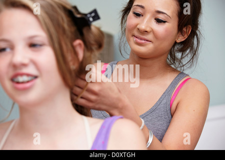 Girl styling friend's hair Stock Photo