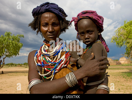 Portrait Of An Erbore Tribe Mother With Colourful Necklaces Holding Her Child, Weito, Omo Valley, Ethiopia Stock Photo