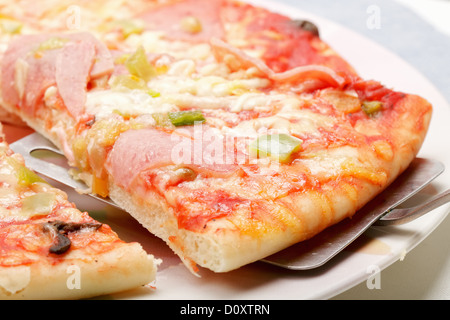 Slice of pizza on spatula closeup Stock Photo