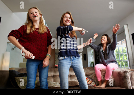 Teenage girls playing video game Stock Photo