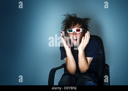 scared man with 3d anaglyph glasses in cinema chair Stock Photo