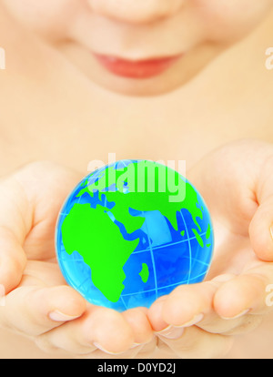boy holds globe in hands Stock Photo
