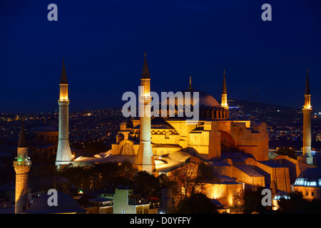 Night lights on Hagia Sophia Islamic mosque and christian Cathedral and Firuz Aga Mosque at twilight in Istanbul Turkey Stock Photo