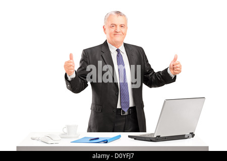 Happy mature businessman standing and giving thumbs up isolated on white background Stock Photo