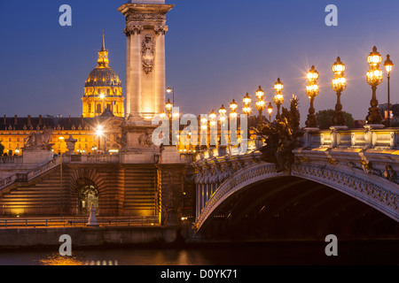 Pont Alexandre III over River Seine with the dome of Hotel des Invalides beyond, Paris, France Stock Photo