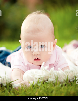 Baby laying on towel Stock Photo