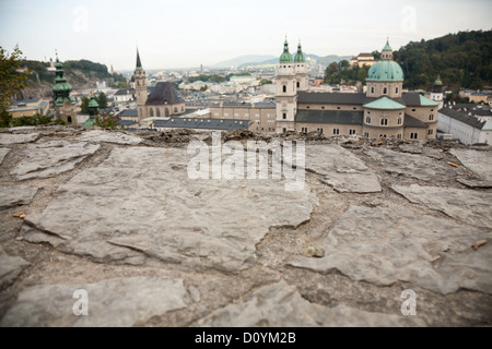 Looking over the stone wall on the way up to Salzburg's Festung to the domes and spires of several of the city's churches below. Stock Photo