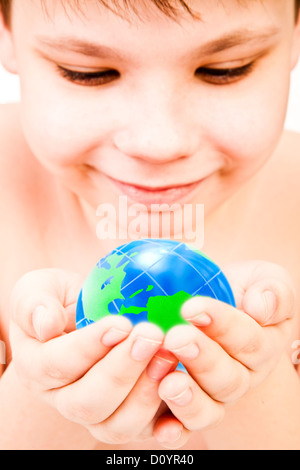 boy holds globe in hands Stock Photo