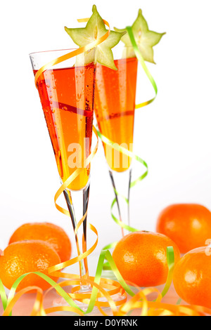 Two orange alcohol cocktails with carambola and mandarines isolated on white background Stock Photo